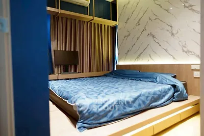 Modern bedroom with stylish marble accent wall and cozy blue bedding