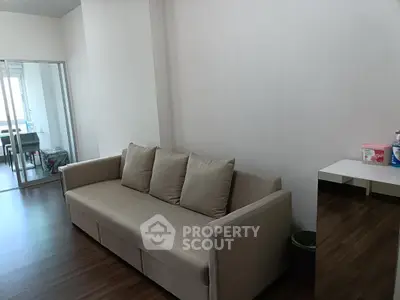 Modern living room with sleek sofa and wooden flooring, ideal for contemporary urban living.