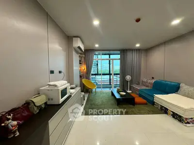 Spacious modern living room with large windows and stylish furniture, offering a cozy and inviting atmosphere.