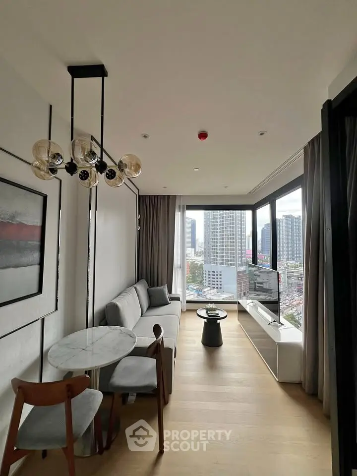 Modern living room with panoramic city view, stylish furniture, and elegant lighting in a high-rise apartment.