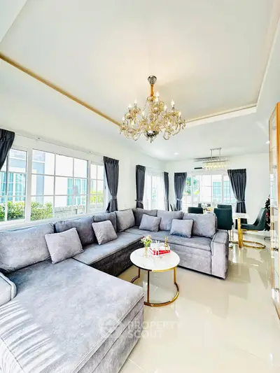 Luxurious living room with elegant chandelier and spacious L-shaped sofa