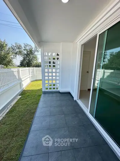 Charming balcony with modern tiles and lush garden view, perfect for relaxation and outdoor enjoyment.