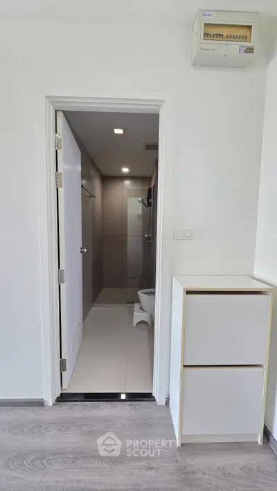 Modern bathroom entrance with sleek design and neutral tones