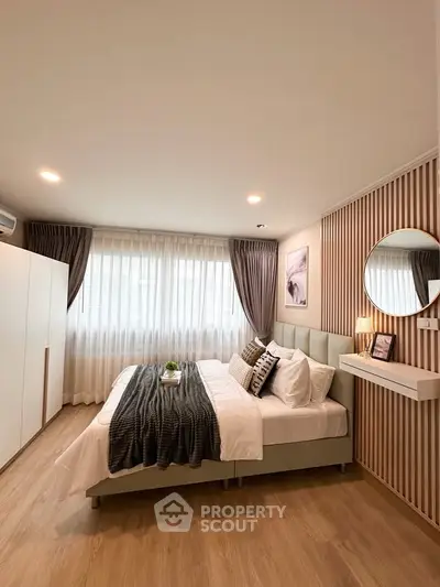 Modern bedroom with stylish decor, large windows, and cozy ambiance
