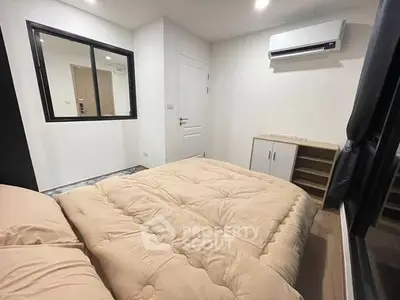 Cozy bedroom with modern air conditioning and ample storage space.