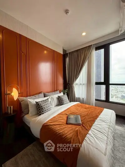 Luxurious bedroom with modern design and city view, featuring stylish decor and cozy ambiance.