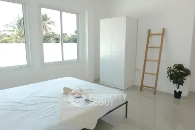 Bright minimalist bedroom with large windows and modern decor