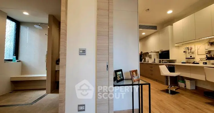 Modern open kitchen with sleek design and adjacent shower area