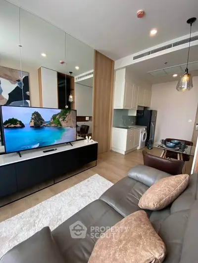 Modern living room with sleek furniture and integrated kitchen appliances in a stylish apartment.