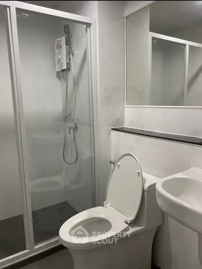 Modern bathroom with glass shower enclosure and sleek fixtures