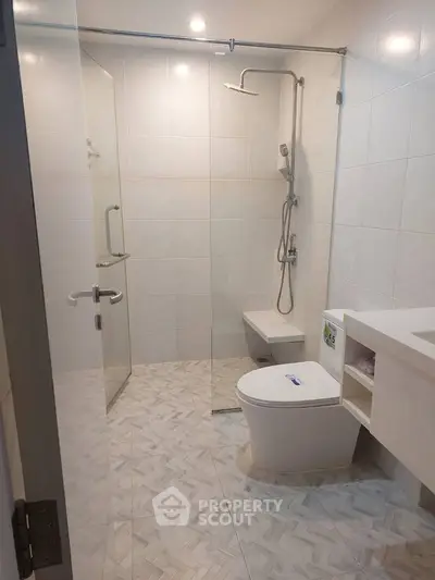 Modern bathroom with sleek shower and toilet in a minimalist design