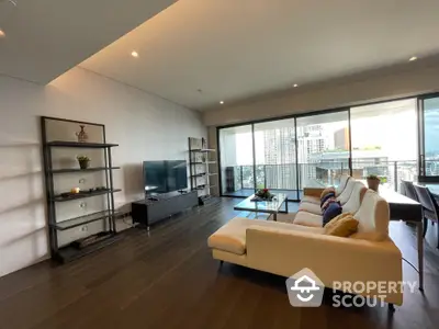 Spacious modern living room with city view and large balcony in luxury apartment