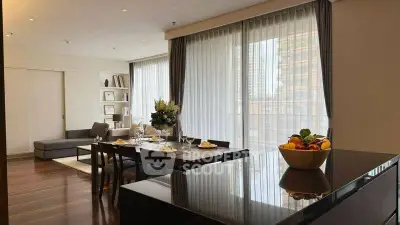 Luxurious open-plan living and dining area with elegant decor and abundant natural light.