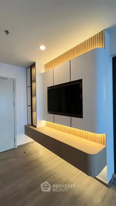 Modern living room with sleek TV wall unit and ambient lighting
