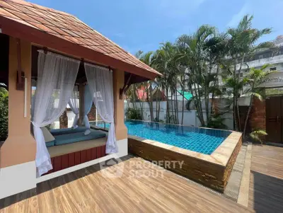 Luxurious outdoor pool area with elegant cabana and tropical landscaping