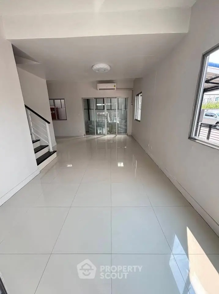 Spacious modern living room with sleek tile flooring and large windows