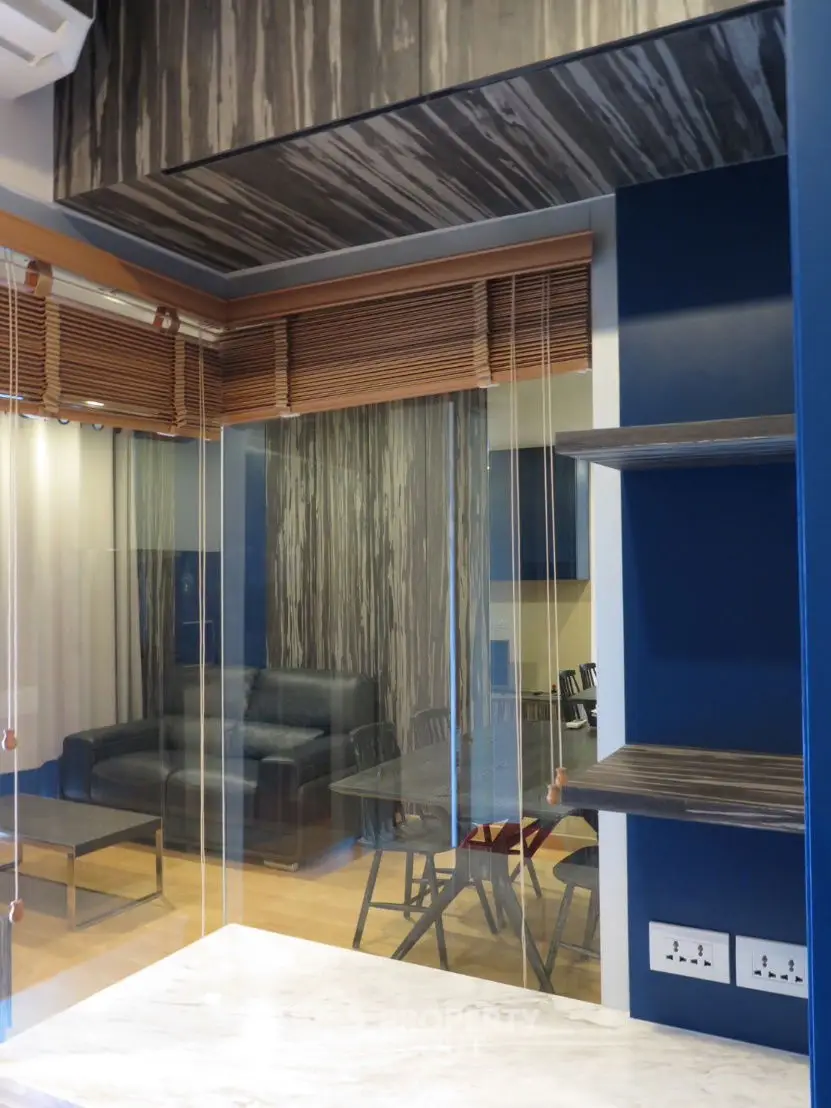Modern living room with blue accents and stylish wooden blinds