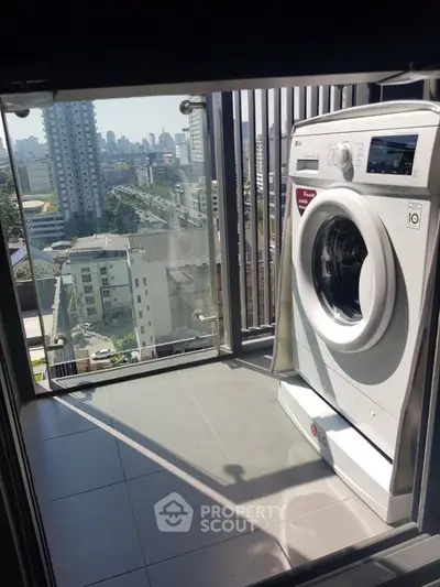 Modern balcony with city view and washing machine, perfect for urban living.