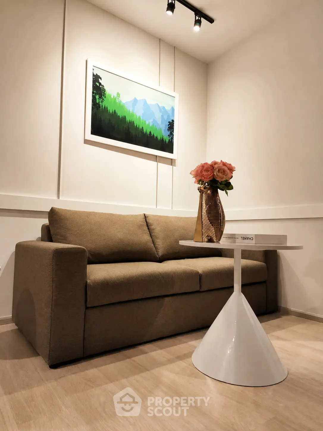 Cozy living room with modern sofa, stylish table, and elegant decor in a well-lit space.