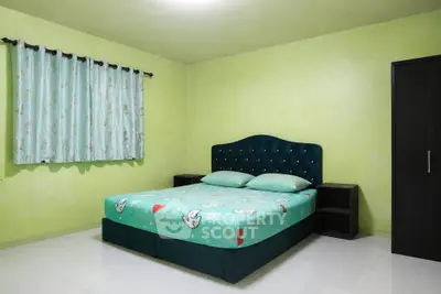 Cozy bedroom with green walls and stylish bed in modern apartment