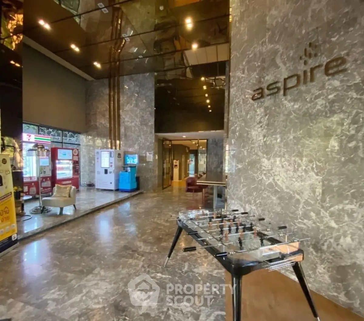 Luxurious building entrance with marble floors and modern decor.