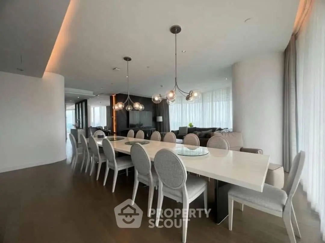 Luxurious open-plan living and dining area with modern lighting and elegant decor.