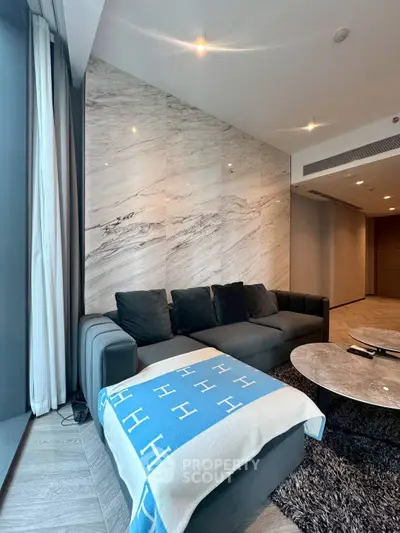 Luxurious modern living room with elegant marble wall and plush sofa
