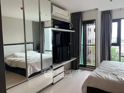 Modern bedroom with mirrored wardrobe and balcony view