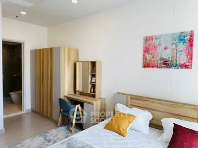 Modern bedroom with stylish furniture and colorful artwork, featuring a cozy bed and a sleek wardrobe.