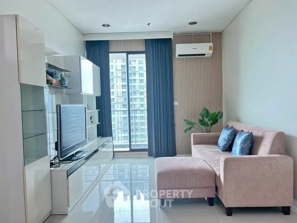 Modern living room with sleek furniture and large window offering city view