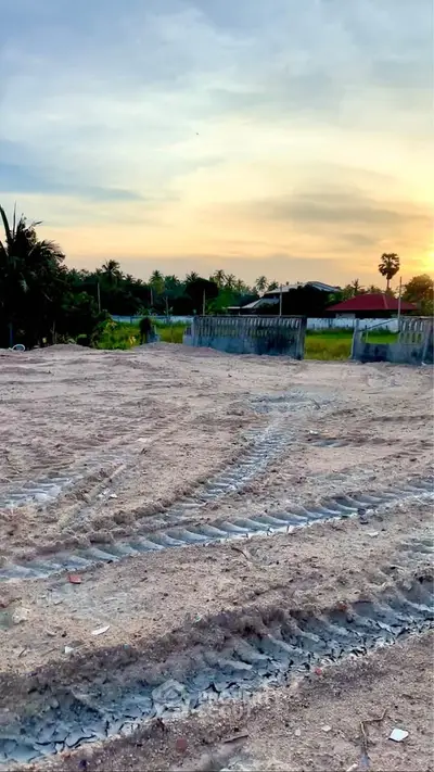 Scenic sunset view over a serene residential plot ready for development.