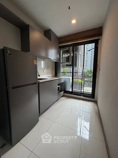 Modern kitchen with sleek appliances and city view from window