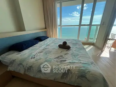 Stunning bedroom with ocean view and natural light, featuring modern decor and cozy ambiance.