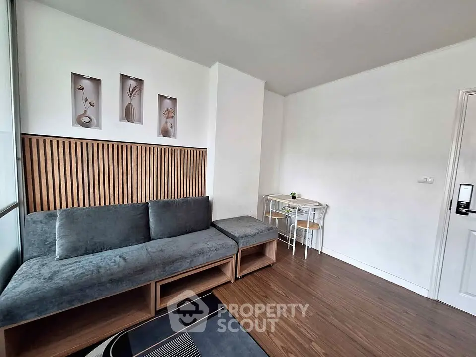 Modern living room with stylish decor and cozy seating area, perfect for relaxation.
