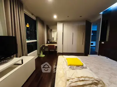 Luxurious bedroom with city view, modern furnishings, and elegant decor in prime location.