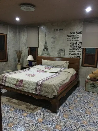 Charming bedroom with cozy decor and unique wall art, perfect for relaxation.