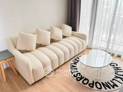 Modern living room with stylish beige sofa and unique alphabet rug