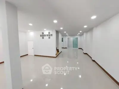 Spacious modern interior with sleek white walls and glossy tiled flooring