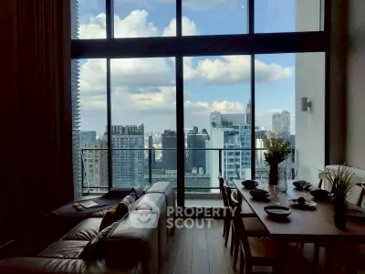 Luxurious high-rise living room with stunning city view and elegant dining area.