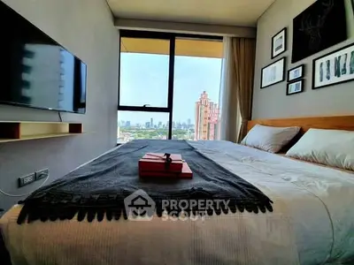 Modern bedroom with city view, featuring stylish decor and wall-mounted TV.