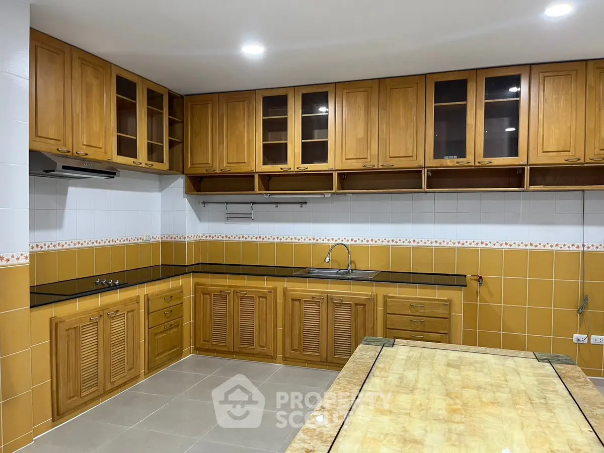 Spacious kitchen with wooden cabinets and modern design