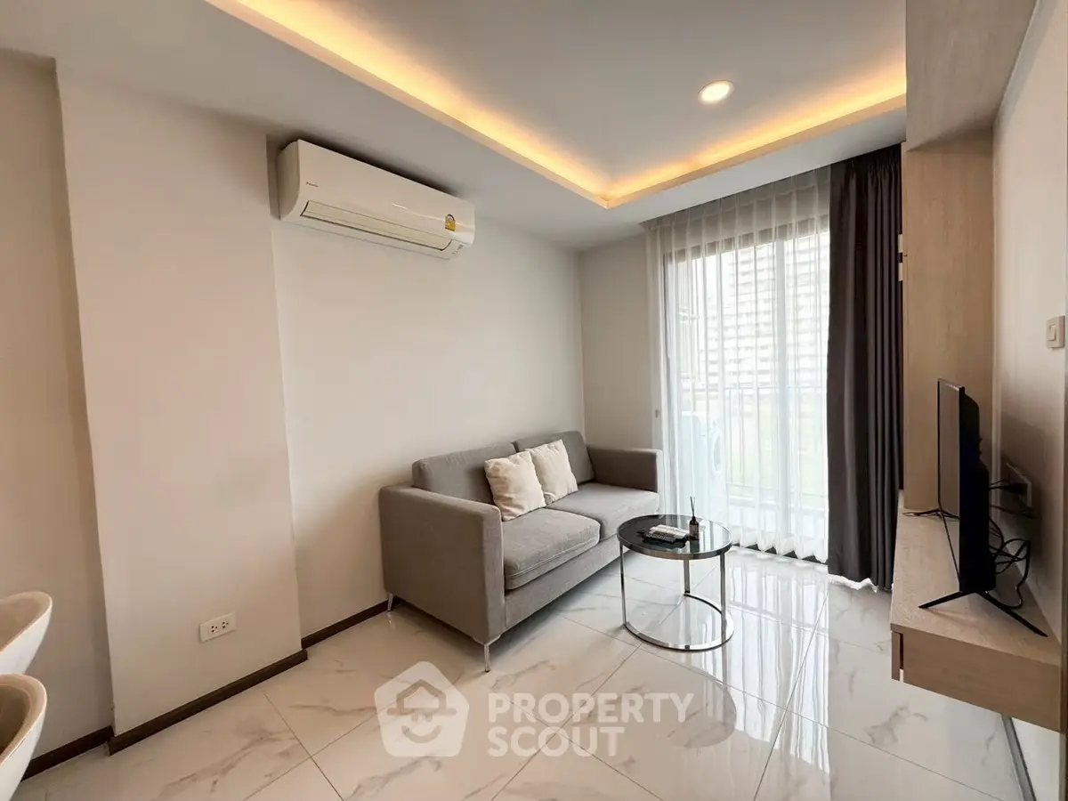 Modern living room with sleek design, featuring a cozy sofa, flat-screen TV, and large window with city view.