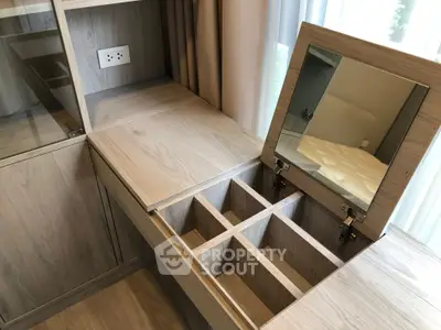 Elegant wooden vanity with mirror and storage compartments in modern bedroom.