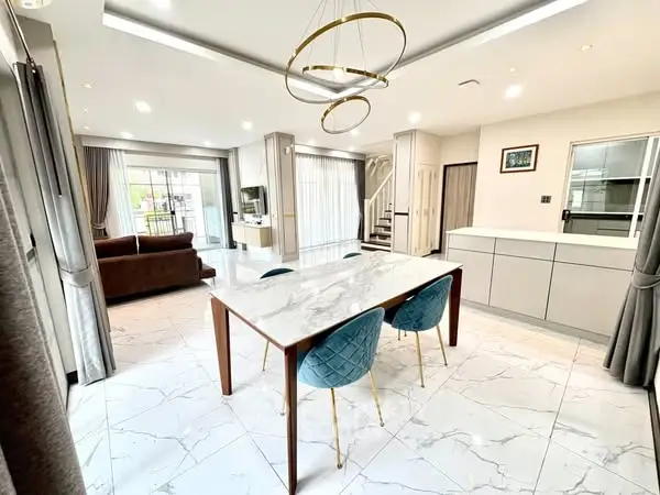Luxurious open-plan living room with elegant marble flooring and modern furnishings.