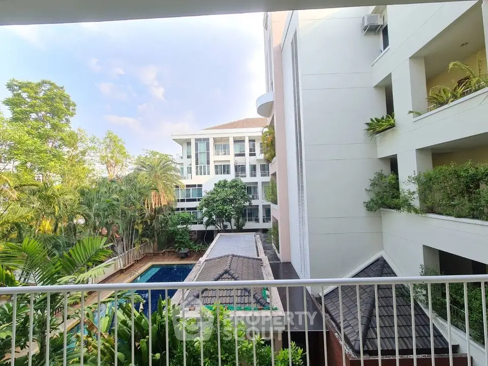 Stunning condo view with lush greenery and poolside tranquility