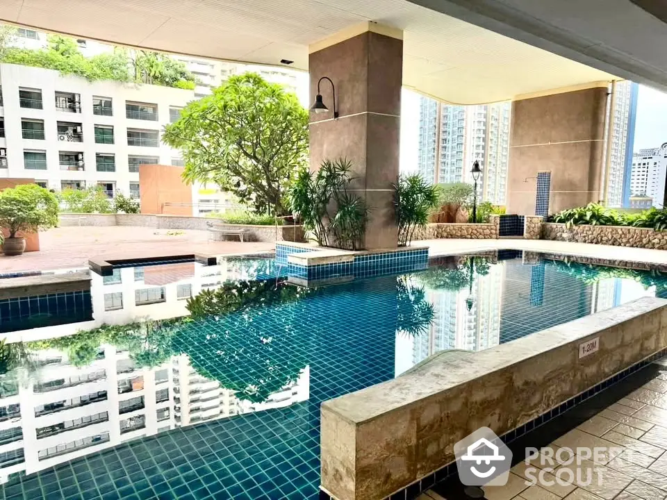 Luxurious condominium pool area with stunning city views and lush greenery