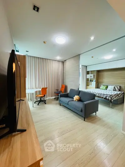 Modern studio apartment with cozy living area and stylish decor