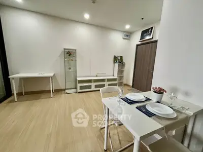 Modern minimalist dining area with sleek furniture and elegant decor in a cozy apartment setting.