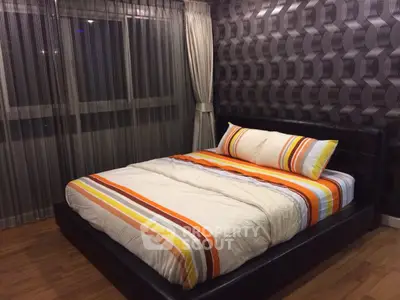 Stylish bedroom with modern decor and cozy bedding in a contemporary apartment.