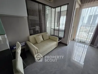 Modern living room with sleek design and large windows offering city views